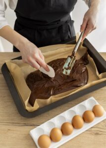 poring batter for baking brownies